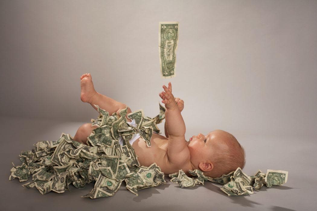 Baby playing in dollar bills