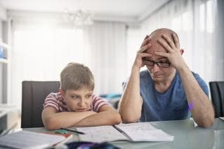 Father and son looking stressed