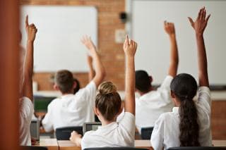 School children raising hands