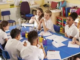 Children sitting around a table at school