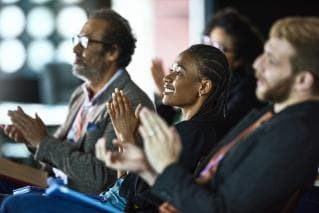 People clapping at event