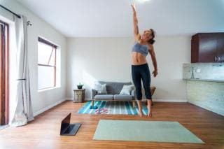 Woman jumping up to touch the ceiling