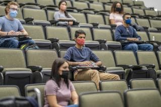 University students in lecture theatre wearing Covid protective masks