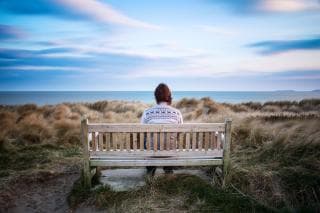 Man sitting alone on a bench