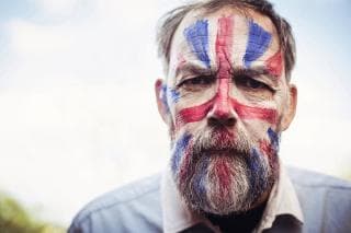 Mature man with Union Jack flag painted onto his face