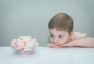 Boy looking at marshmallows