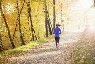 Person running on a track in woods