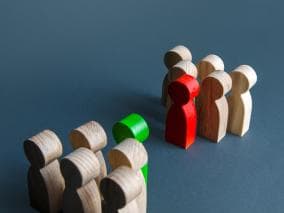 Two groups of wooden figures facing off