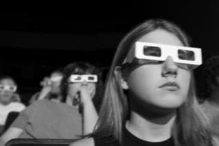 Movie watchers wearing 3d glasses