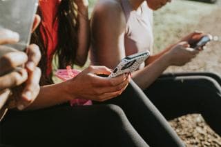 Mobile phone in teenagers hands