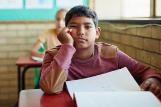 Schoolboy looking bored