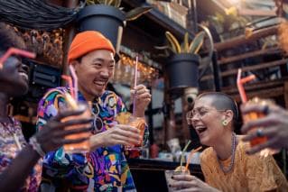 Friends sharing a laugh over drinks