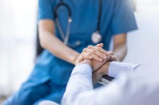 Doctor holding patient's hand