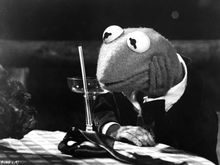 Black and white photo of Kermit the Frog looking dejected