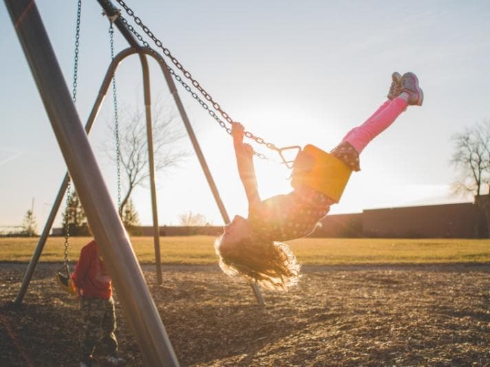 Children playing on swings