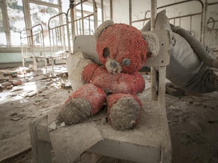 Tattered teddy bear in a ruined hospital