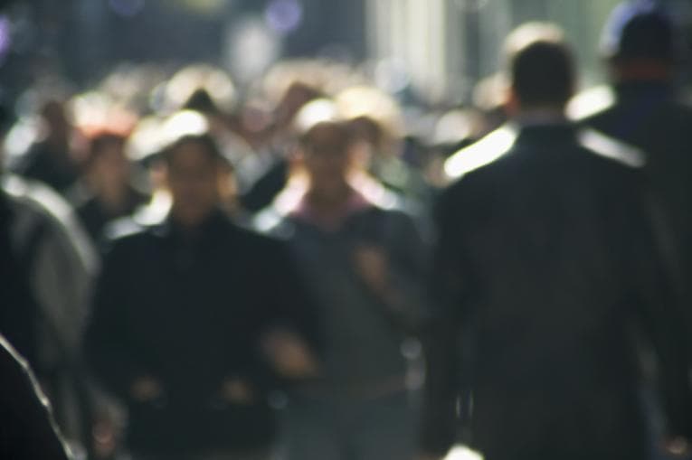 A blurred image of people in the street