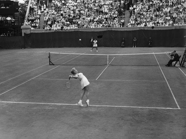 Darlene Hard serves to Althea Gibson during the Women's Singles tournament at Wimbledon 1958 - copyright Bettmann - Contributor via Getty Images.