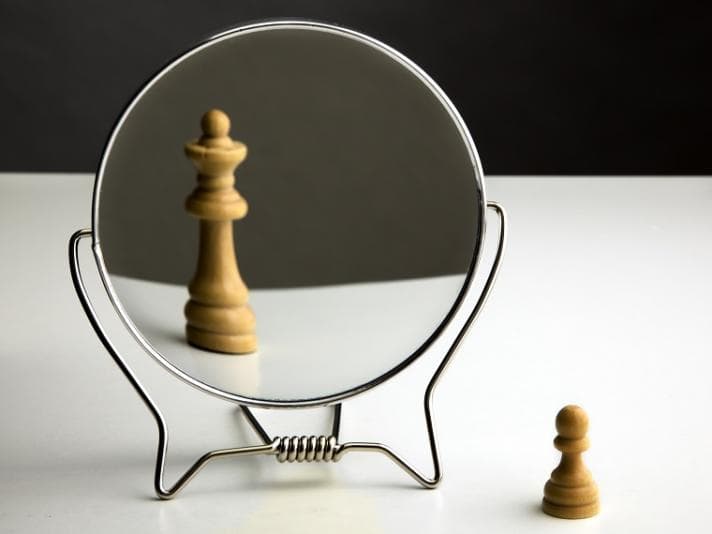 Distorted image of a chess piece in a mirror