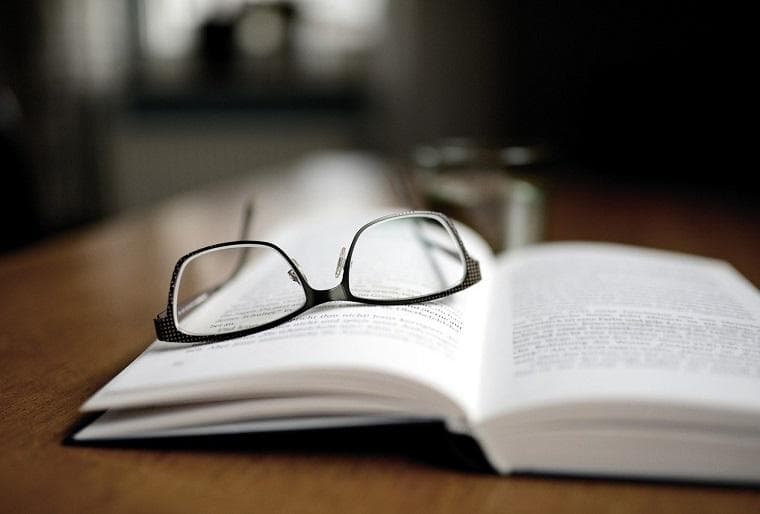 Pair of glasses resting on an open book