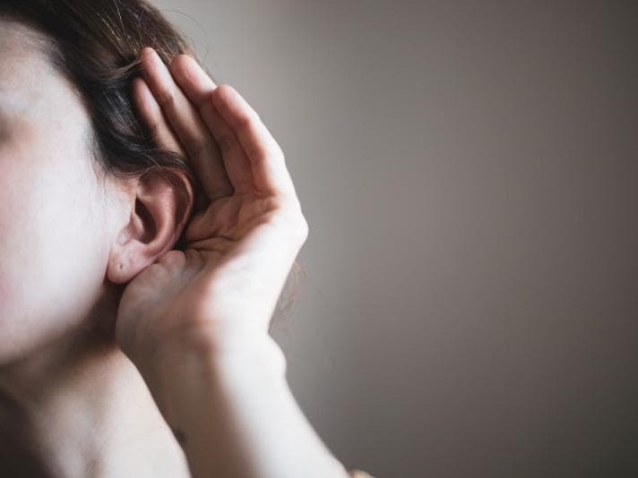 Person cupping their ear