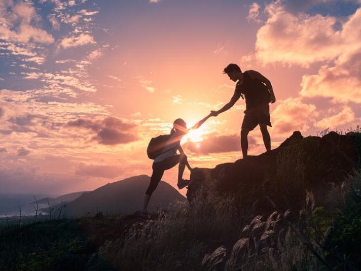 Photograph of two people hiking