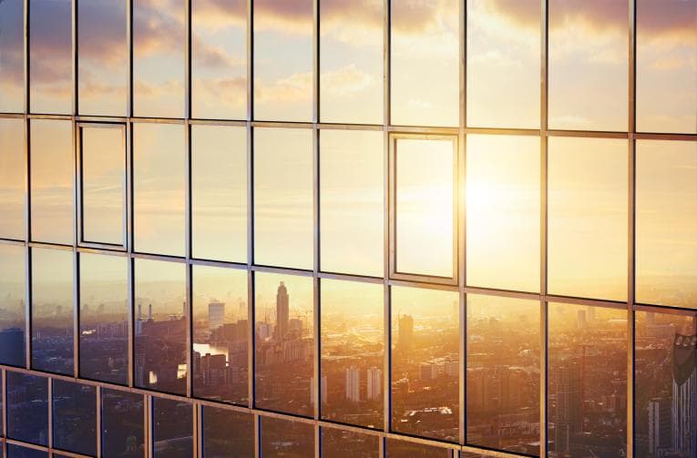 Reflection of the sunset in the windows of a high rise building