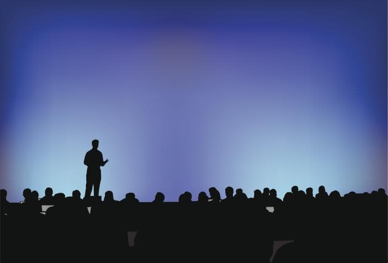 Silhouette of a man presenting at a conference