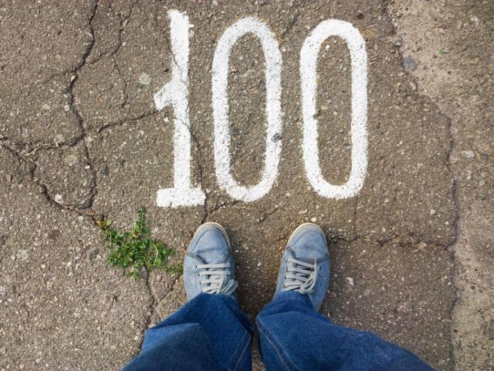 The number 100 written on the ground in chalk