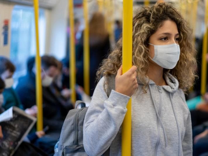 Woman wearing mask on train