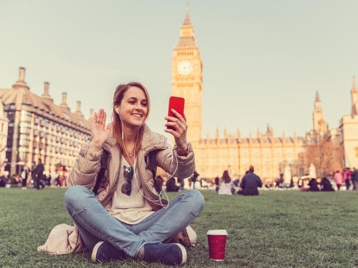 Young woman making a video call outside