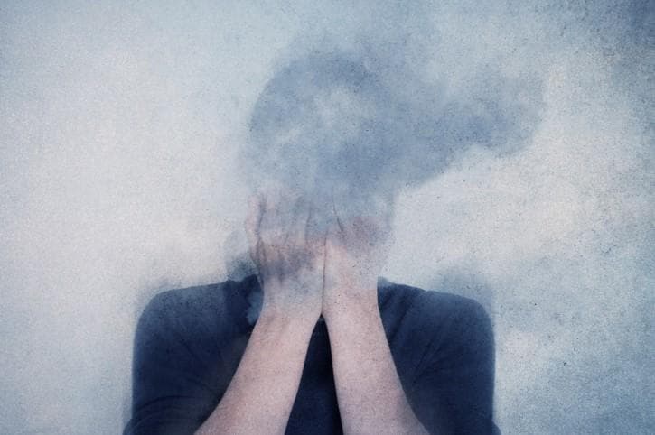 a person whose face is obscured by smoke