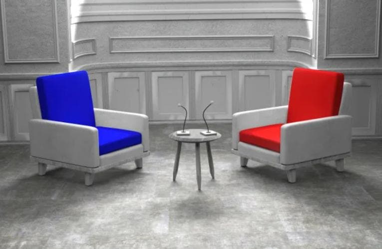 Blue and red chairs set up for a debate