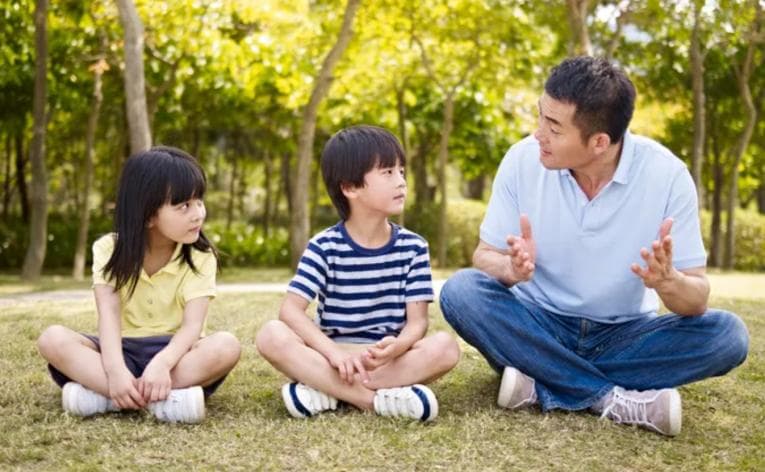 Father talking to his children outside