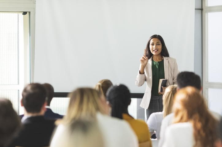 Female teacher standing in front of class