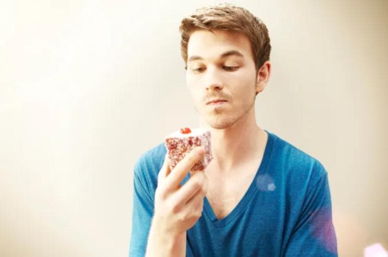 Man staring pensively at cake