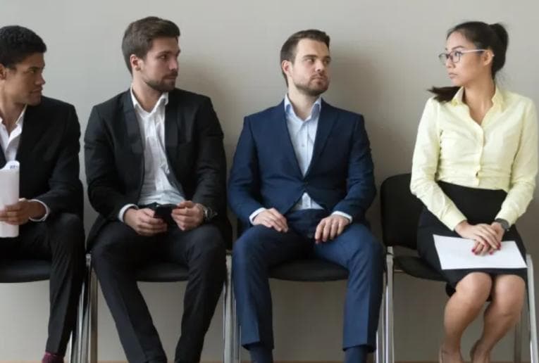 Three men and one woman waiting for an interview