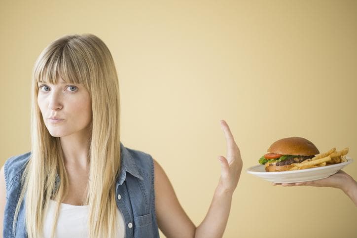 Woman refusing hamburger