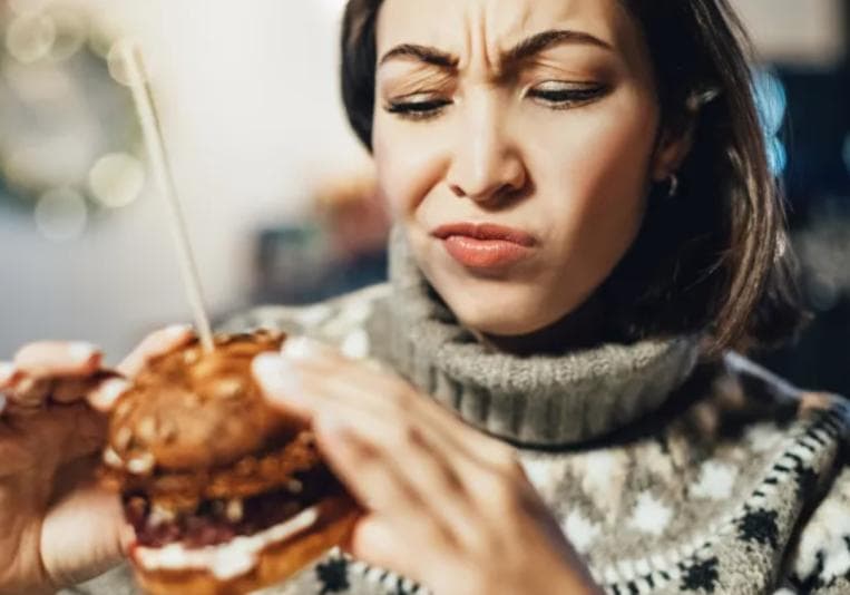 Woman staring at hamburger