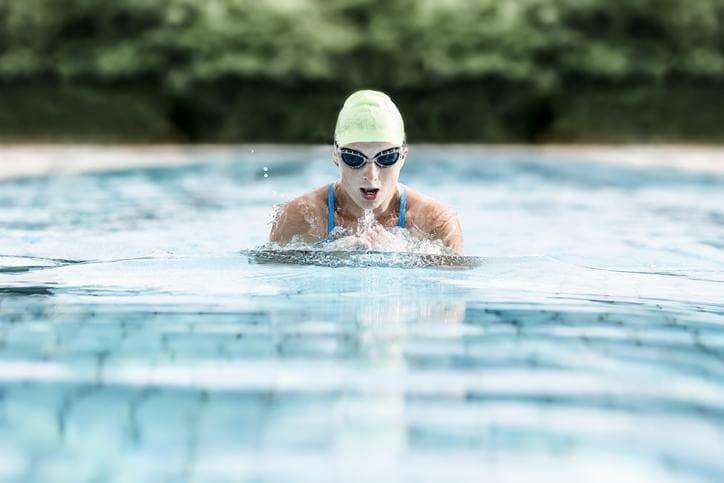 Young woman swimming in swimming pool