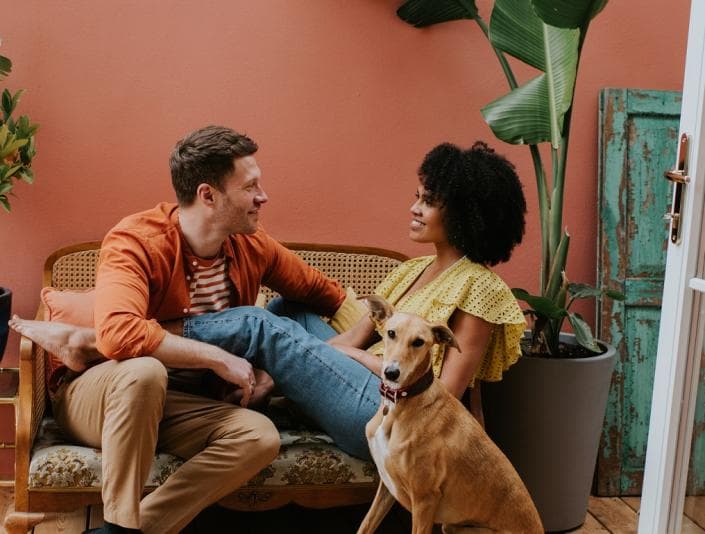 Happy couple sitting with their dog