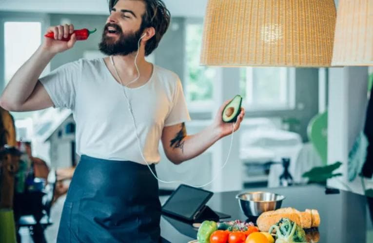 Hip young man cooking vegetables in the kitchen