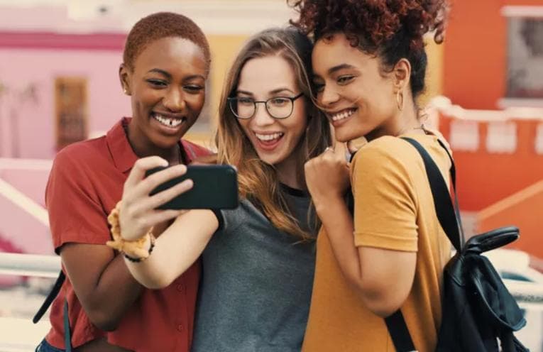 Smiling young women taking a selfie