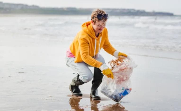 Woman cleaning the beach