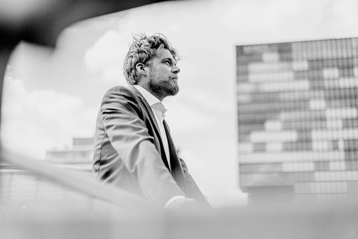 Businessman standing on bridge