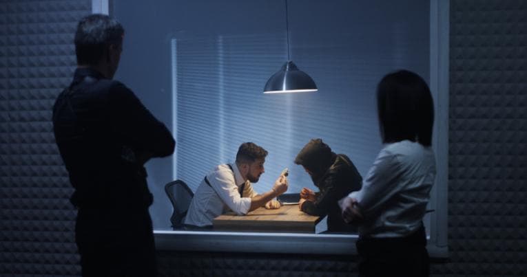 Investigators watching an interrogation