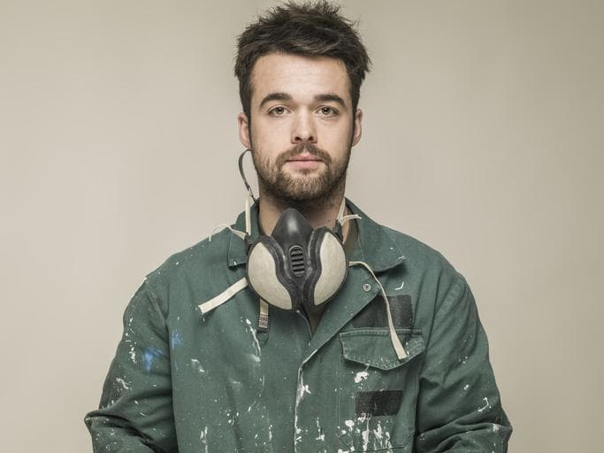 Young man wearing safety mask and overalls