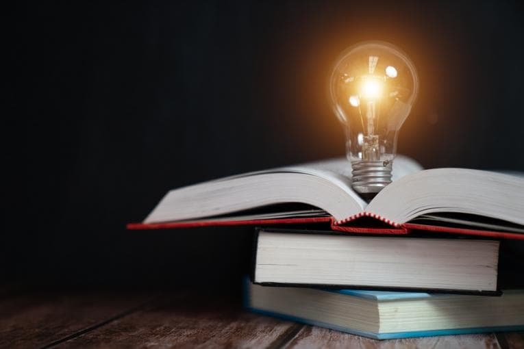 Lightbulb on a pile of books