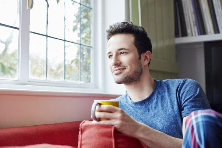 Man sitting and thinking while drinking tea