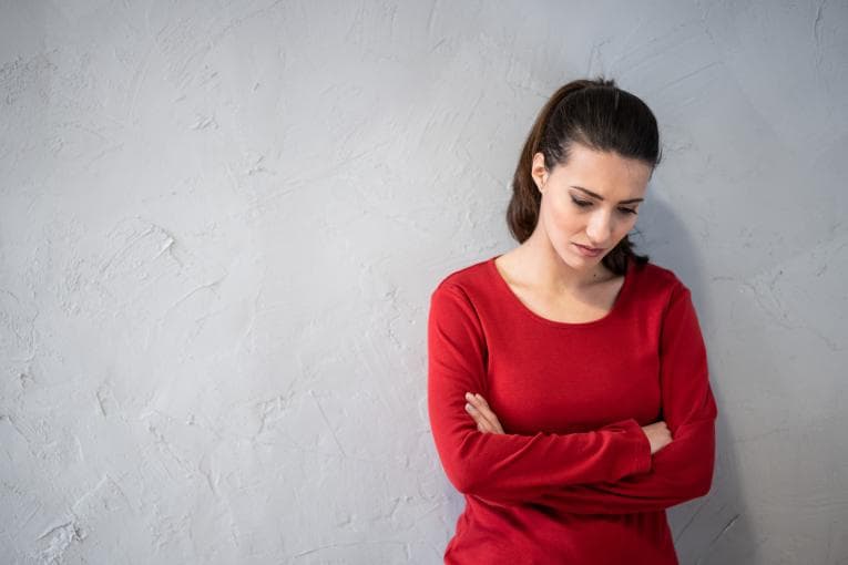 Woman looking down in expression of shame